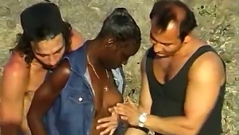 Two White Guys Pleasure A Black Woman At The Seaside In Threesome