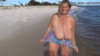 Enjoy A Free Promotional Preview Of A Mature Woman Showing Off Her Curves And Assets In A Swimsuit On The Beach